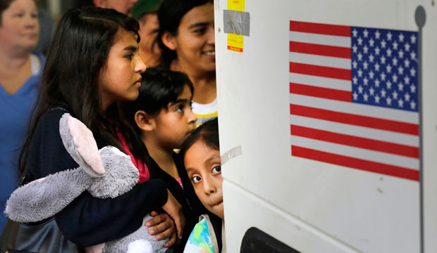 Children from El Salvador and Guatemala board a bus after being released from a family detention center in Texas on July 7, 2015. (AP/Eric Gay)