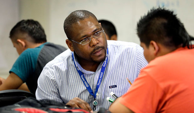 A teacher works with his student at Liberty High School in Houston, Texas, on July 1, 2014. (AP/David J. Phillip)