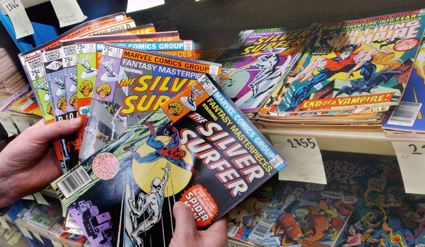 Didier Gaboulaud, head of the French National Museum for Comic Books and Images, displays comics donated by Marvel Enterprises in 2004. (AP/Bob Edme)