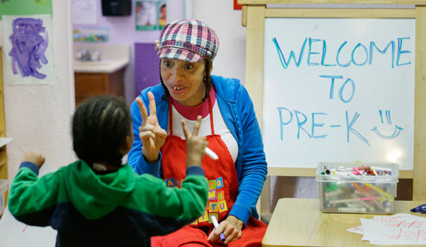 A pre-kindergarten teacher talks with a student on October 21, 2014, in Seattle, Washington. (AP/Ted S. Warren)