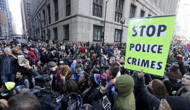 Chicago protesters call for Mayor Rahm Emanuel and Cook County State's Attorney Anita Alvarez to resign on December 9, 2015. (AP/Charles Rex Arbogast)