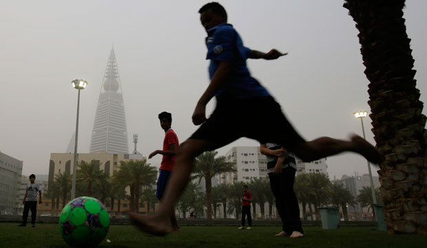 Saudi youth play soccer in a park during a dust storm in Riyadh, Saudi Arabia, on April 25, 2015. (AP/Hasan Jamali)