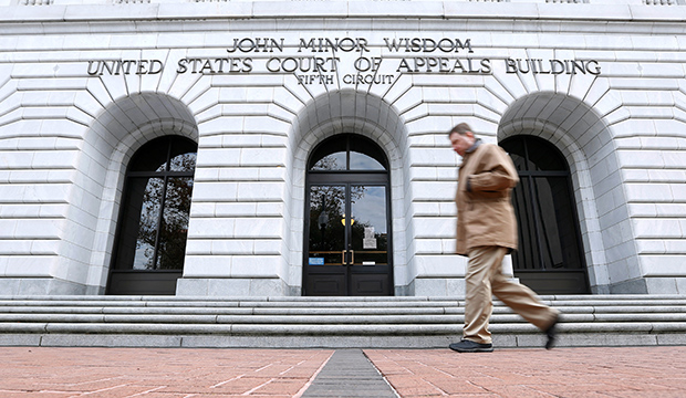 A man walks in front of the U.S. Court of Appeals for the 5th Circuit, January 7, 2015. (AP/Jonathan Bachman)