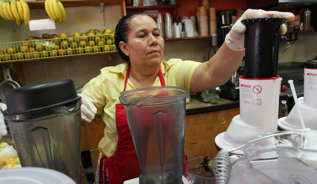A woman works at Jugueria de regreso al Eden, in the Queens borough of New York, on August 3, 2015. (AP/Tina Fineberg)
