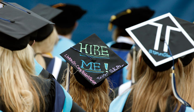 Graduates, including one looking for a job, are seated during The George Washington University's commencement exercises on May 17, 2015, in Washington, D.C. (AP/Alex Brandon)