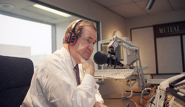 Pat Buchanan listens to a caller during his radio show in Washington, February 16, 1995. (AP/Charles Tasnadi)