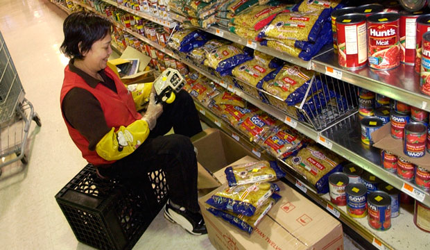 A woman stocks the shelves at a Super 88 supermarket on November 23, 2006, in Malden, Massachusetts. (AP/Lisa Poole)