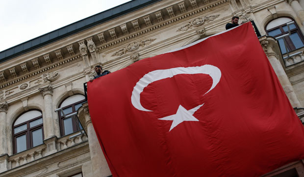 A Turkish national flag is hung on a balcony on Istiklal Street in Istanbul on March 20, 2016. (AP/Emrah Gurel)