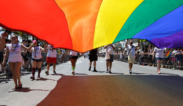 Participants carry a rainbow flag during a pride parade in Miami Beach, Florida, on April 10, 2016. (AP/Lynne Sladky)