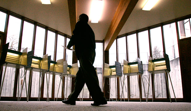 A voter walks toward an empty bank of voting stations at a polling place in Seattle on the day of Washington state's 2008 presidential primary. (AP/Elaine Thompson)