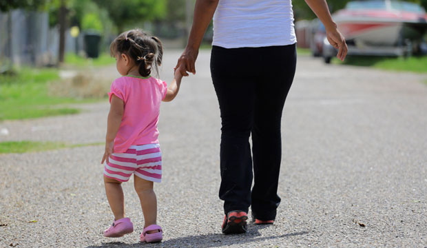 A woman walks with her 2-year-old daughter in Sullivan City, Texas, on September 16, 2015. (AP/Eric Gay)
