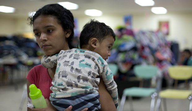 A mother holds her 14-month-old son at Sacred Heart Catholic Church in McAllen, Texas. (AP/Rebecca Blackwell)