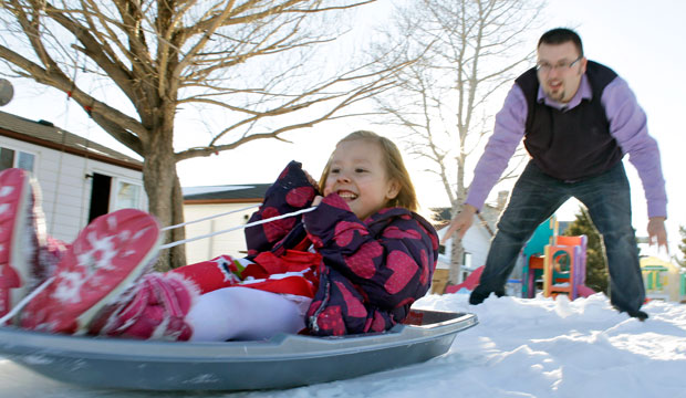 Coy Mathis is pushed on a sled by her father at their home in Fountain, Colorado, in February 2013. (AP/Brennan Linsley)