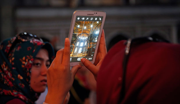 A tourist uses her phone to take a picture inside the Byzantine-era Hagia Sophia in Istanbul on May 10, 2015. (AP/Lefteris Pitarakis)