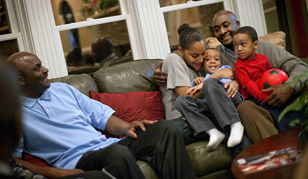 Shelton Haynes, 33, far right, sits with his wife Tiisha and sons Jamir, 2, right, and Jayden, 4, while with his father Cleveland Haynes Jr., left, on a visit to his parents' home, in Duluth, Georgia, February 2011. (AP/David Goldman)