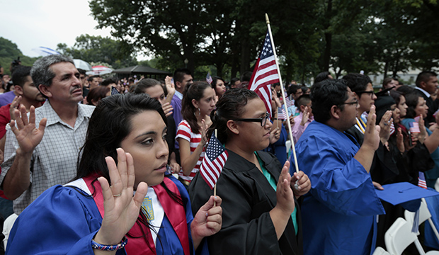 DREAMers and parents take an oath in a mock citizenship ceremony during a