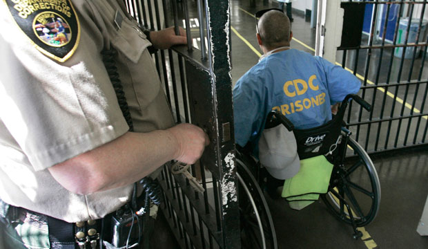 An inmate in a wheelchair goes through a check point at the California Medical Facility, in Vacaville, California, on April 9, 2008. (AP/Rich Pedroncelli)
