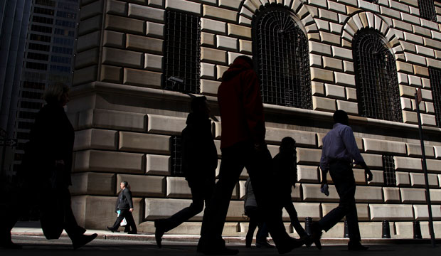 Pedestrians walk past the Federal Reserve Bank of New York in October 2012. (AP/Seth Wenig)