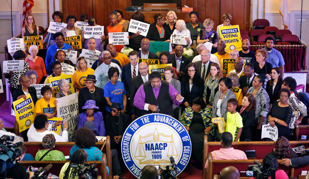 North Carolina NAACP president Rev. William Barber, center at podium, speaks at a news conference in Richmond, Virginia, Tuesday, June 21, 2016. (AP/Steve Helber)