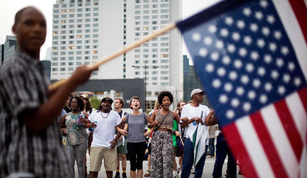 Protesters link arms as they block an intersection in the Buckhead neighborhood of Atlanta during a march against the recent police shootings of African Americans on Monday, July 11, 2016. (AP/David Goldman)
