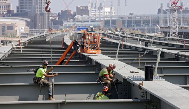 Ironworkers secure a cross member on a highway bridge under construction in Cleveland, August 2013. (AP/Mark Duncan)