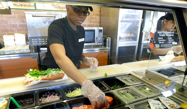 Workers make sandwiches in Seattle on March 3, 2015. (AP/Ted S. Warren)