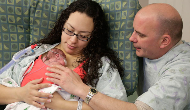 Bryan Niedermeyer and Angelica Juarez visit with their daughter Olivia at Advocate Children's Hospital in Chicago on March 15, 2016. (AP/M. Spencer Green)