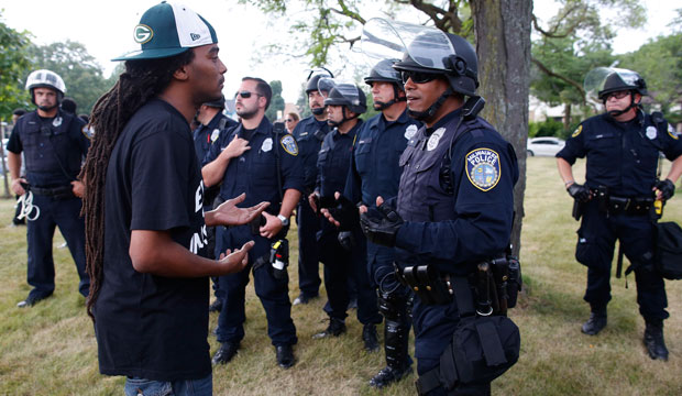 A man speaks with police in a park in Milwaukee, August 2016. (AP/ Jeffrey Phelps)