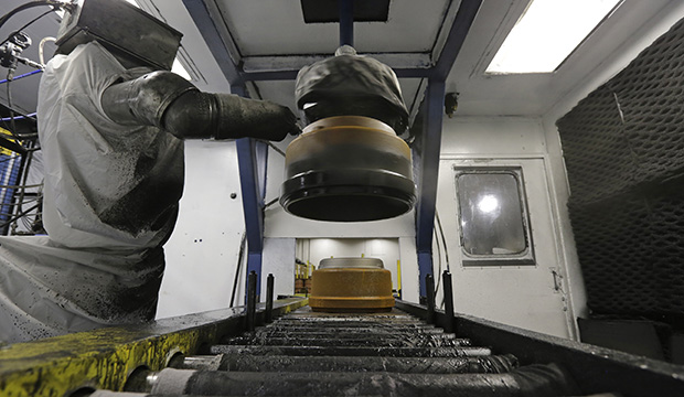 A robot paints brake drums at a factory in Cullman, Alabama, January 2013. (AP/Dave Martin)