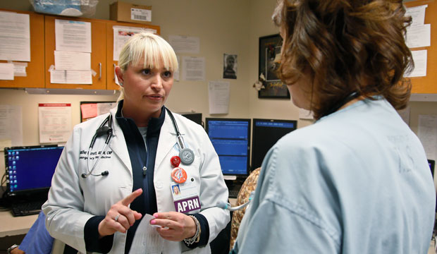 Jennifer Parrott, a certified nurse practitioner, left, talks with a doctor about a patient at the Oklahoma Health Sciences Emergency Department, in Oklahoma City, Friday, May 13, 2016. (AP/Sue Ogrocki)