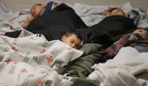 Children sleep in a holding cell at a U.S. Customs and Border Protection processing facility in Brownsville, Texas, on June 18, 2014. (AP/Eric Gay)