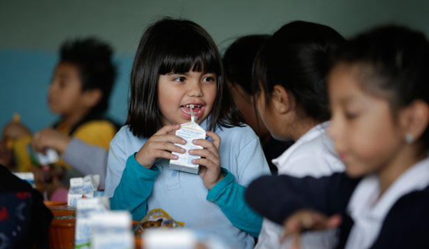 An elementary student drinks her milk in the cafeteria on January 13, 2015, in Los Angeles. (AP/Jae C. Hong)