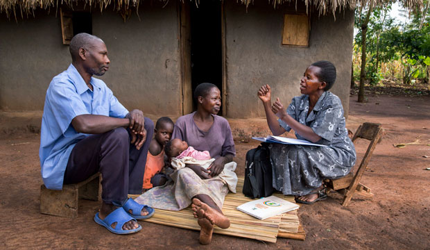 A community health worker visits with a family on July 21, 2014, in Mbale, Uganda. (Getty/Jonathan Torgovnik)
