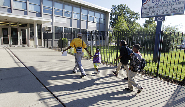 Parents drop their children off at Chicago's Benjamin E. Mays Academy, September 2012. (AP/M. Spencer Green)