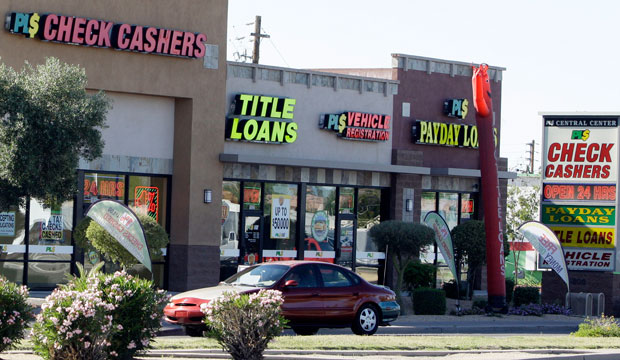 Payday loan businesses advertise their services in Phoenix on April 7, 2010. (AP/Ross D. Franklin)