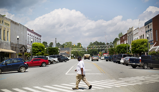 A pedestrian crosses a street in the main business section of Montezuma, Georgia, April 2014. (AP/David Goldman)