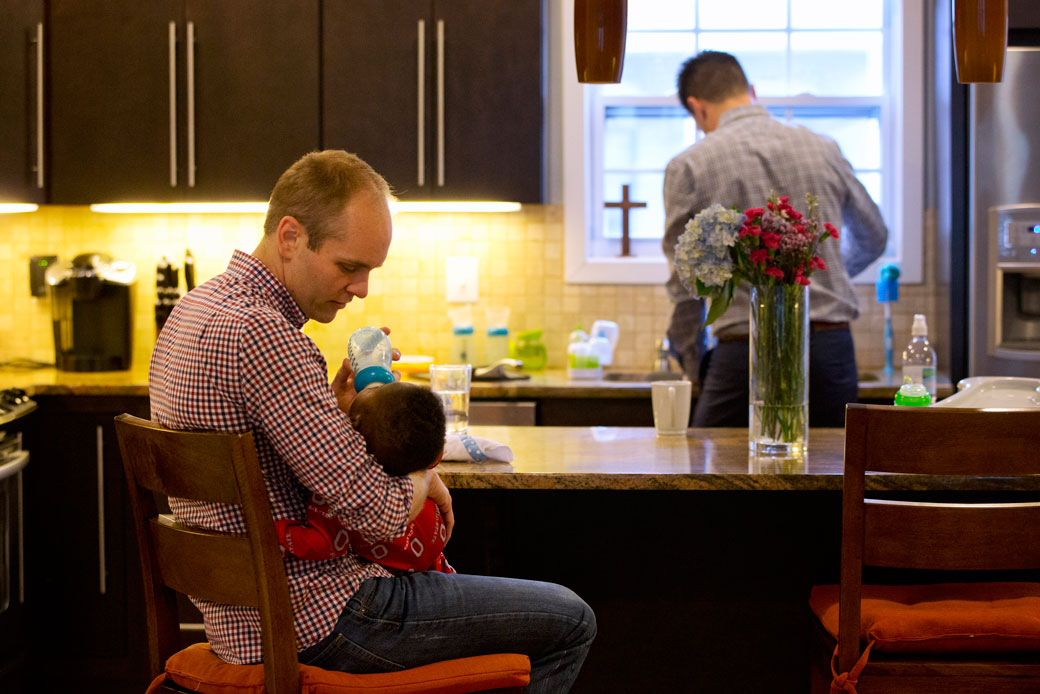 Gregg Pitts feeds his son Thomas Brunson-Pitts, 6 months, a bottle as his husband Brooks Brunson gets ready for work at their home in Washington, D.C., on May 19, 2016. (AP/Jacquelyn Martin)