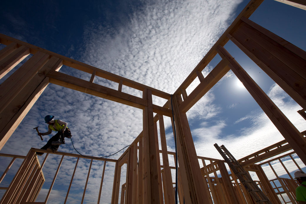 A construction worker works on a house frame for a new home in Chula Vista, California. (AP/Gregory Bull)