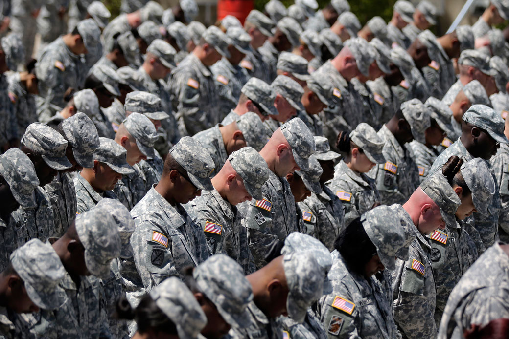 Soldiers bow their heads during a memorial ceremony for shooting victims on April 9, 2014, at Fort Hood, Texas. (AP/Eric Gay)
