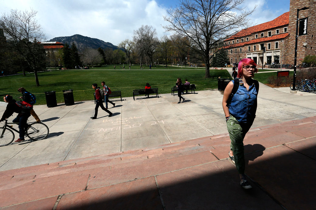 In this April 20, 2015, photo, students walk to and from classes on the campus quad of the University of Colorado, in Boulder. (AP/Brennan Linsley)