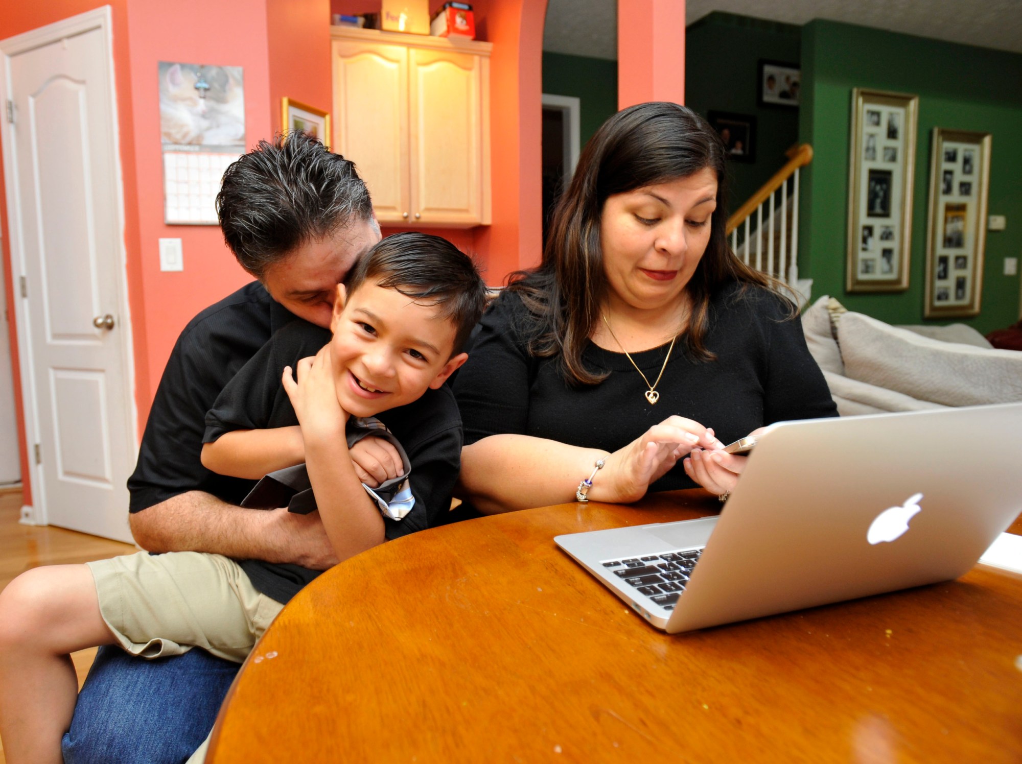 Marisela Martinez-Cola, right, a lawyer and a parent living in an Atlanta suburb with her husband Greg, left, and their 7-year-old son, David, prepare for a typical school and work day Tuesday, Sept. 30, 2014, in Lawrenceville, Ga. The couple send their son to private school and have hired a tutor to improve David's reading _ expenses made possible by Gregs salary as a regional buyer for Costco Wholesale. (AP Photo/David Tulis)