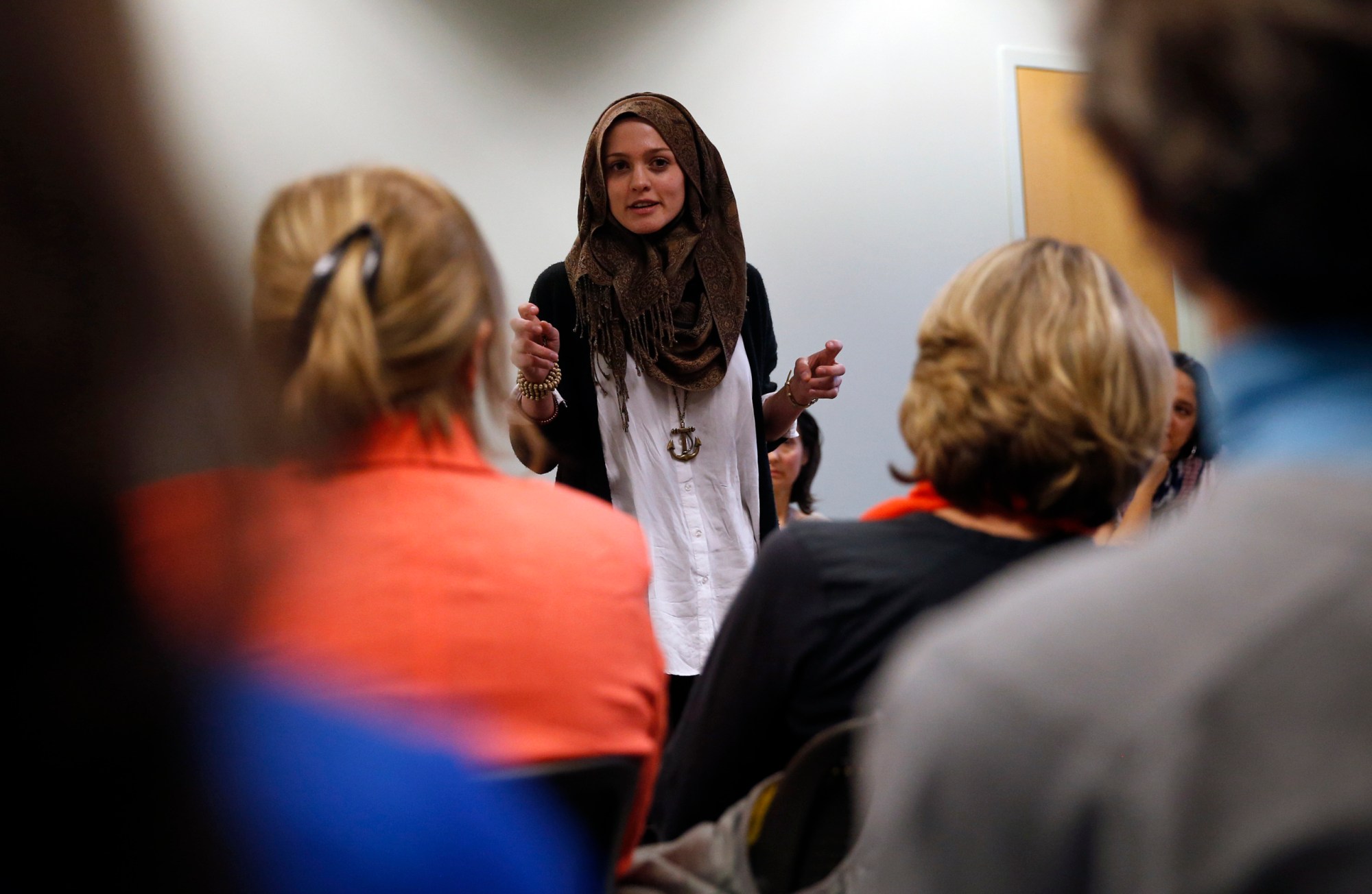 In this April 19, 2016 photo, Syrian-American poet Amal Kassir recites her work during a gathering where immigrants from hostile environments spoke about their lives, at the YWCA in Boulder, Colo. Kassir, a 20-year-old college student, was born in Denver to a father from Syria and a mother from America. A poet who also works in her familys Middle Eastern restaurant, Kassir describes her own life as being intertwined with that of the United States. Is America great? Yes, she says. And its also her best chance. 