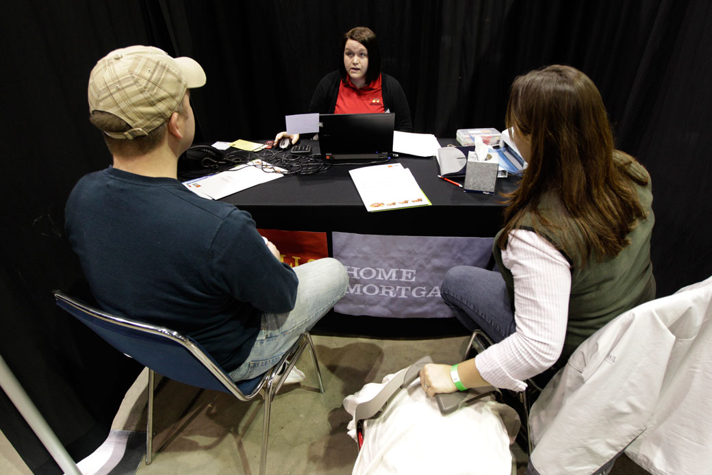 Ryan Gress and his wife Crystal talk with a consumer loan representative in Seattle on January 12, 2012. (AP/Ted S. Warren)