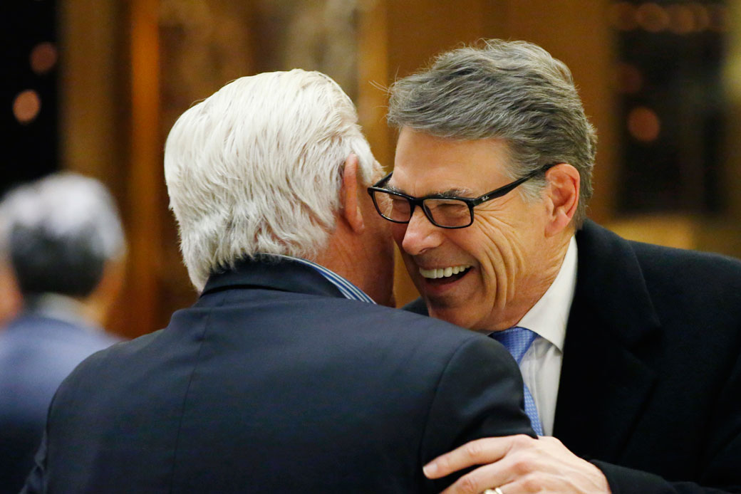 Former Gov. Rick Perry hugs an unidentified man  at Trump Tower in New York on December 12, 2016. (AP/Kathy Willens)