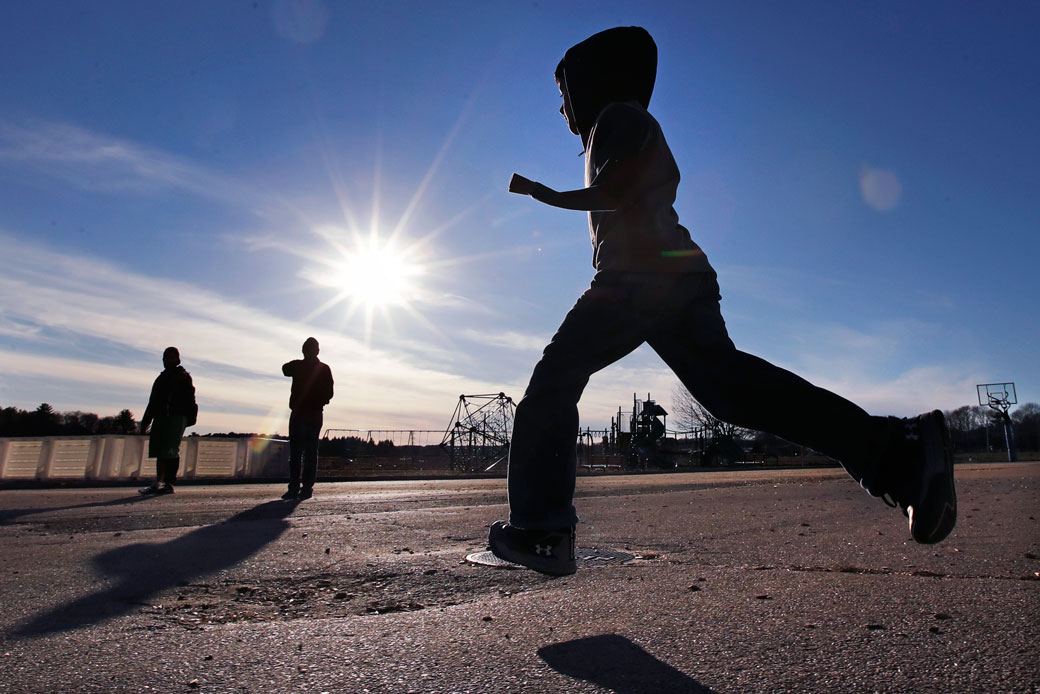 Syrian refugee Ahmad Alkhalaf plays soccer with friends in Sharon, Massachusetts, on December 10, 2016. (AP/Charles Krupa)