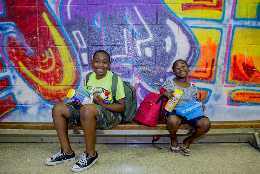 Terrell, left, and Christina Farmer sit on a bench at Philadelphia's Andrew Hamilton School on August 20, 2016. (AP for Clorox/Jeff Fusco)