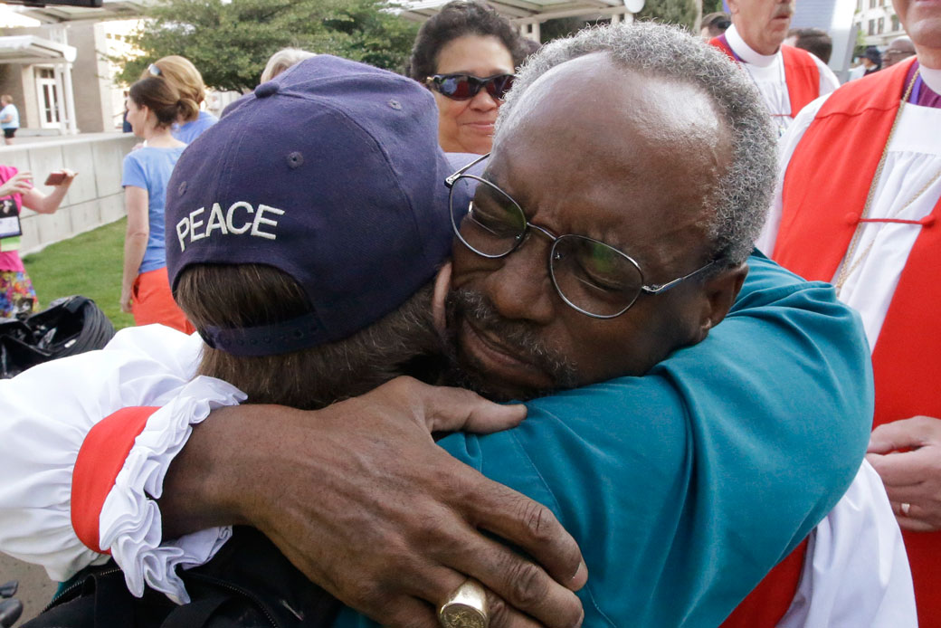 The Rev. Michael Curry gives a hug before a march and rally against gun violence, on June 28, 2015. (AP/Rick Bowmer)