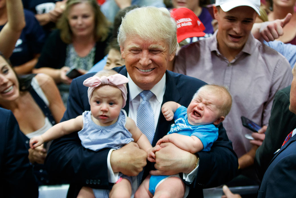 Then-Republican presidential candidate Donald Trump holds a pair of babies, July 2016. (AP/Evan Vucci)