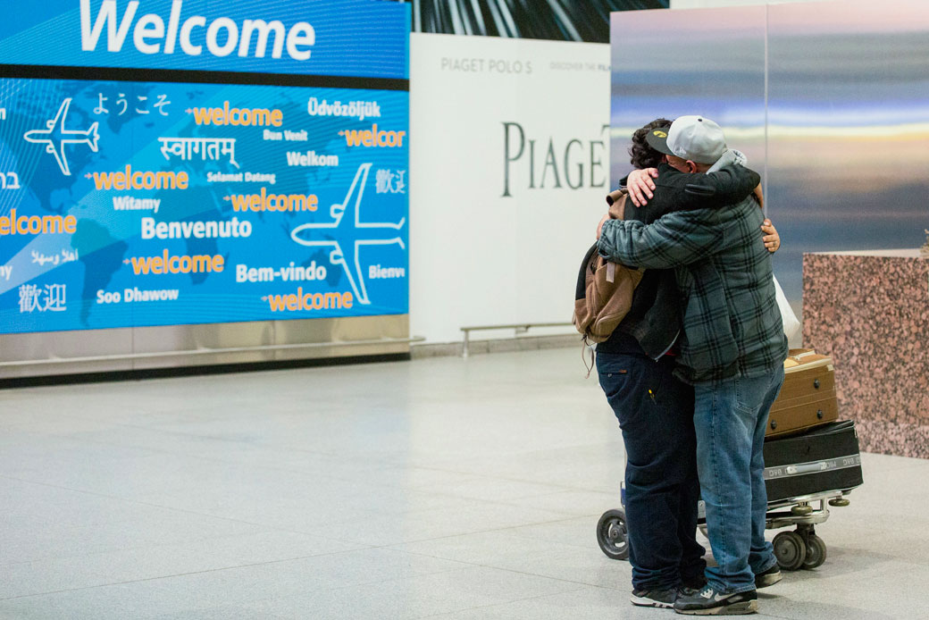 Abdullah Alghazali, right, hugs his 13-year-old son Ali Abdullah Alghazali after the Yemeni boy arrived at John F. Kennedy International Airport in New York, Sunday, February 5, 2017. (AP/Alexander F. Yuan)