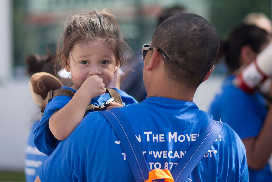A man holds his son at an immigration reform rally in Deerfield Beach, Florida, on August 20, 2014. (AP/J Pat Carter)